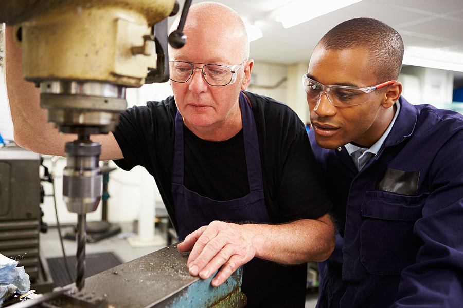Engineer Teaching Apprentice To Use Precision Mill Turning